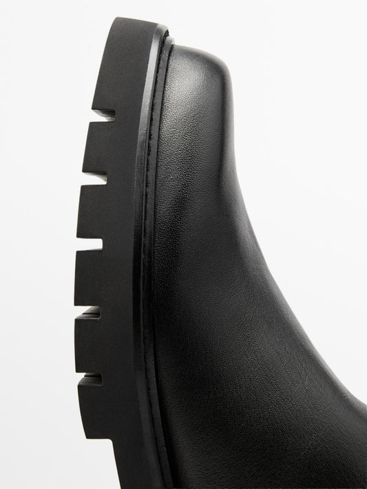 Track sole flat ankle boots