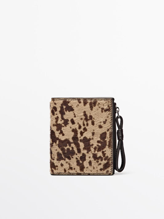 Animal print hair on leather wallet