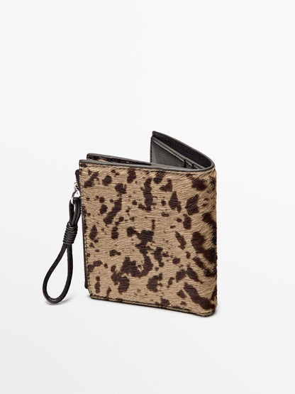 Animal print hair on leather wallet