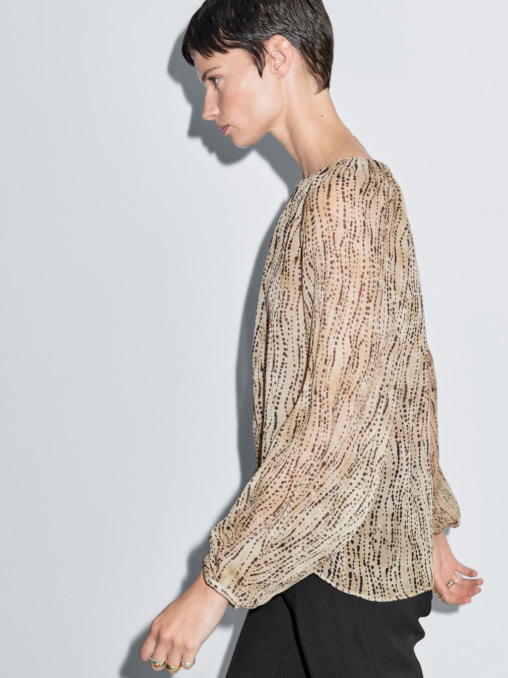 Semi-sheer draped blouse