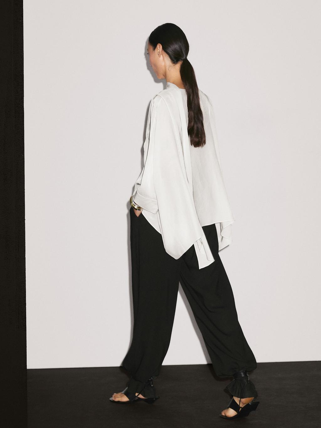 Short flowing cape with sleeve detail