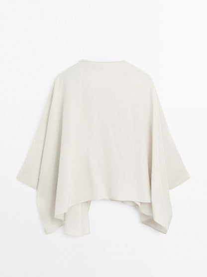 Short flowing cape with sleeve detail