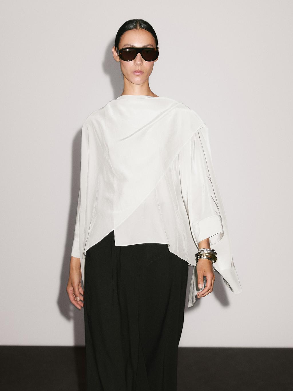 Short flowing cape with sleeve detail