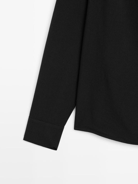 Blouse with crossover detail and button