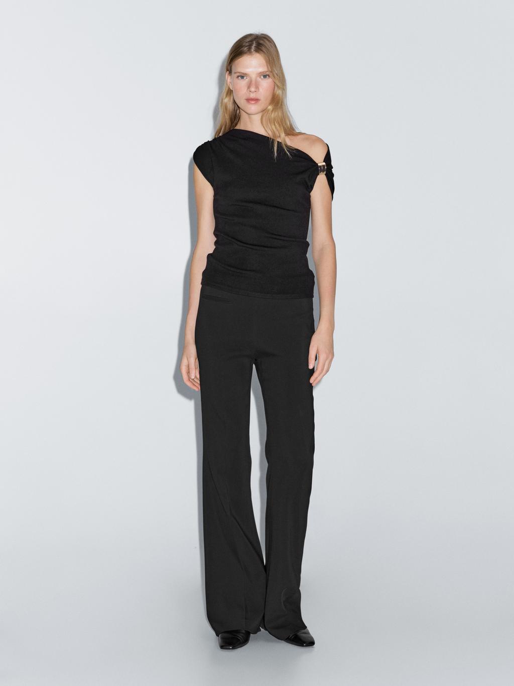 Sleeveless draped top with shoulder applique